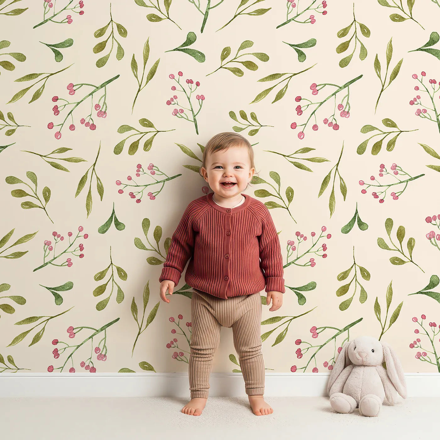 Lovely child standing in front of Whimsy Tots Botanical Berry Sprigs Wallpaper in Cream with berry, leaf, sprig in design.