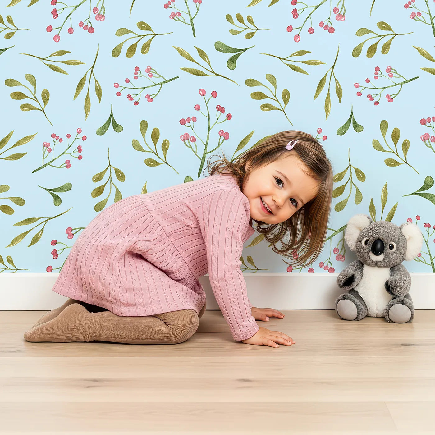 Lovely child standing in front of Whimsy Tots Botanical Berry Sprigs Wallpaper in Sky Blue with berry, leaf, sprig in design.
