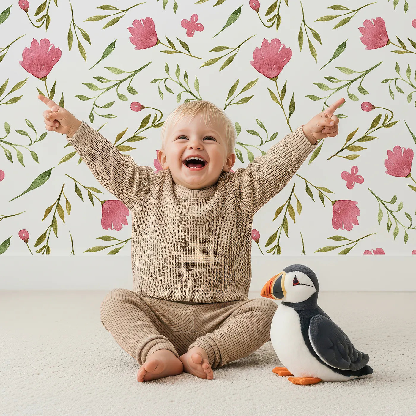 Lovely child standing in front of Whimsy Tots Blushing Petal Tangle Wallpaper in White with flower, leaf, petal, vine in design.