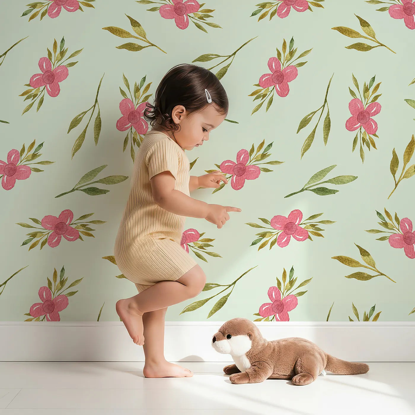 Lovely child standing in front of Whimsy Tots Whimsy Bloom Sprays Wallpaper in Mint Green with flower, leaf, bloom, spray in design.