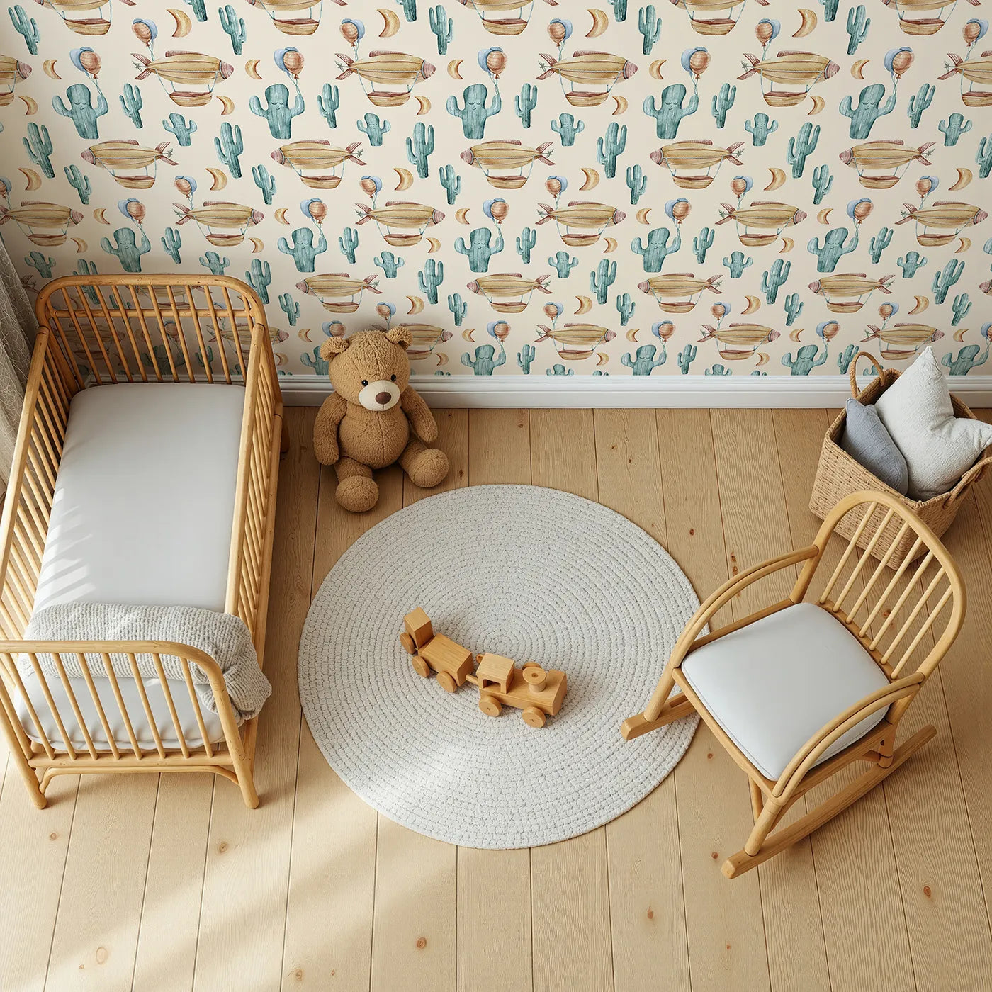 Top-Down view of Whimsy Tots' Desert Balloon Voyage Wallpaper in Cream (W3278C).Airships float through a cozy cream sky above smiling cacti and golden moons.
