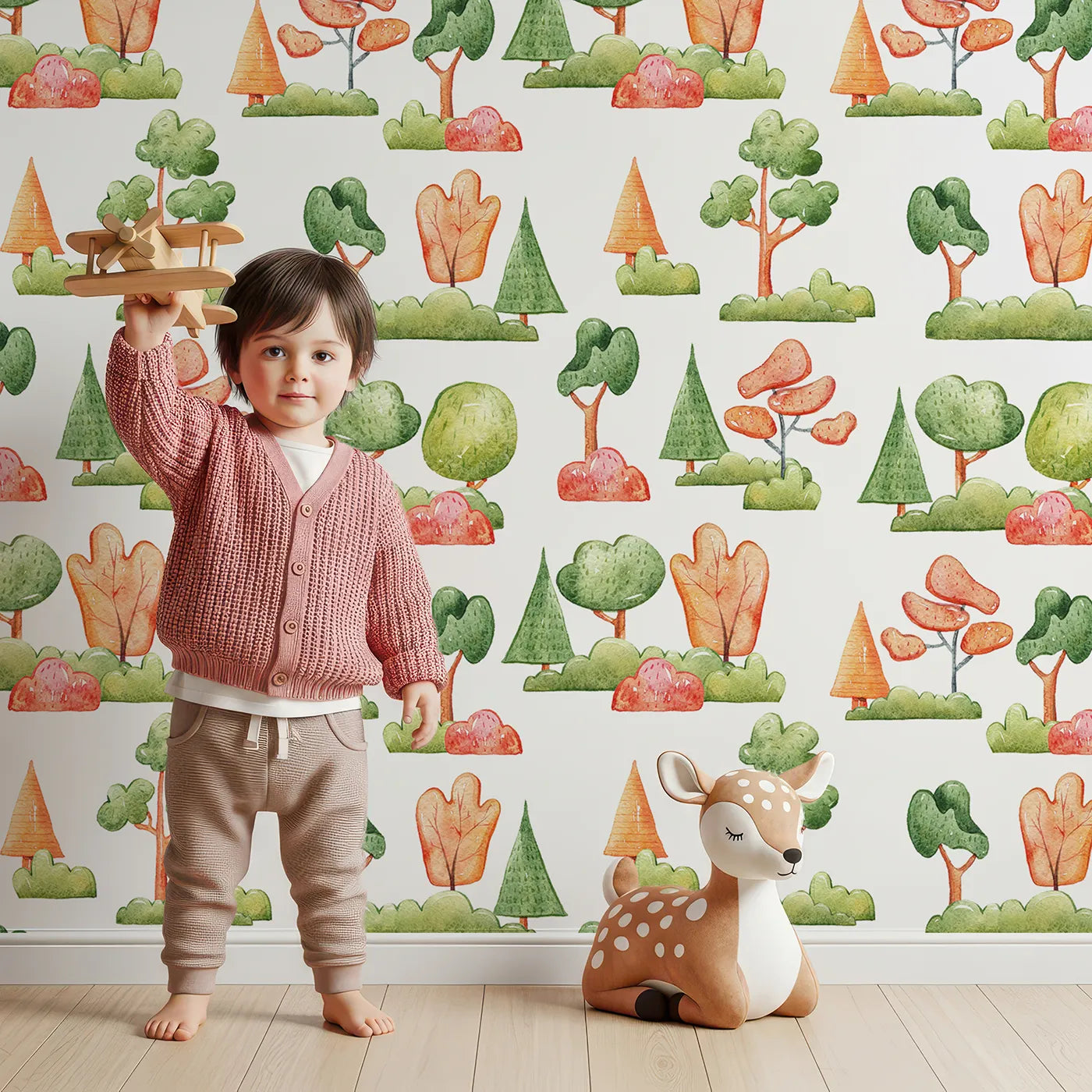 Lovely child standing in front of Whimsy Tots Autumn Meadow Grove Wallpaper in White with tree, bush in design.