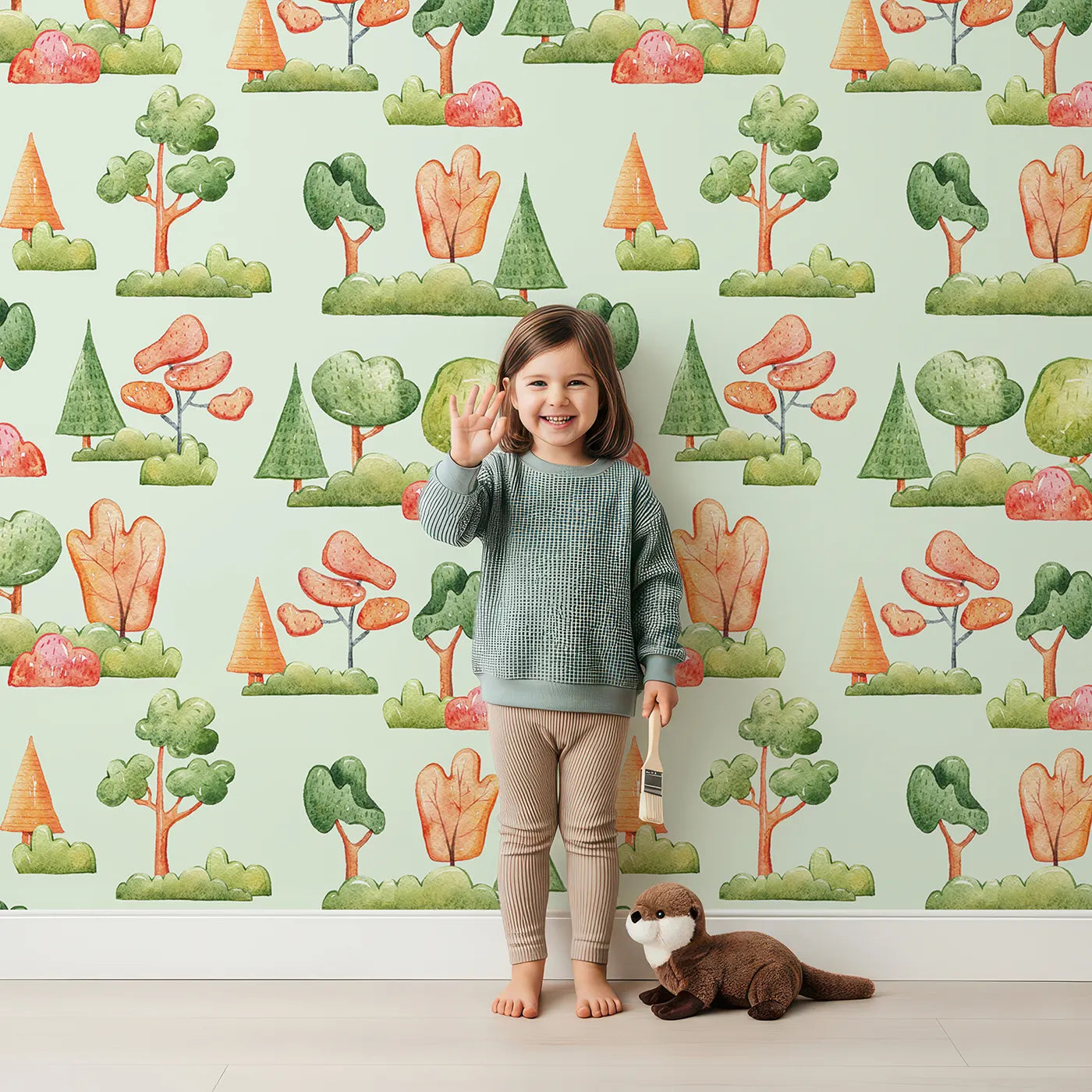 Lovely child standing in front of Whimsy Tots Autumn Meadow Grove Wallpaper in Mint Green with tree, bush in design.