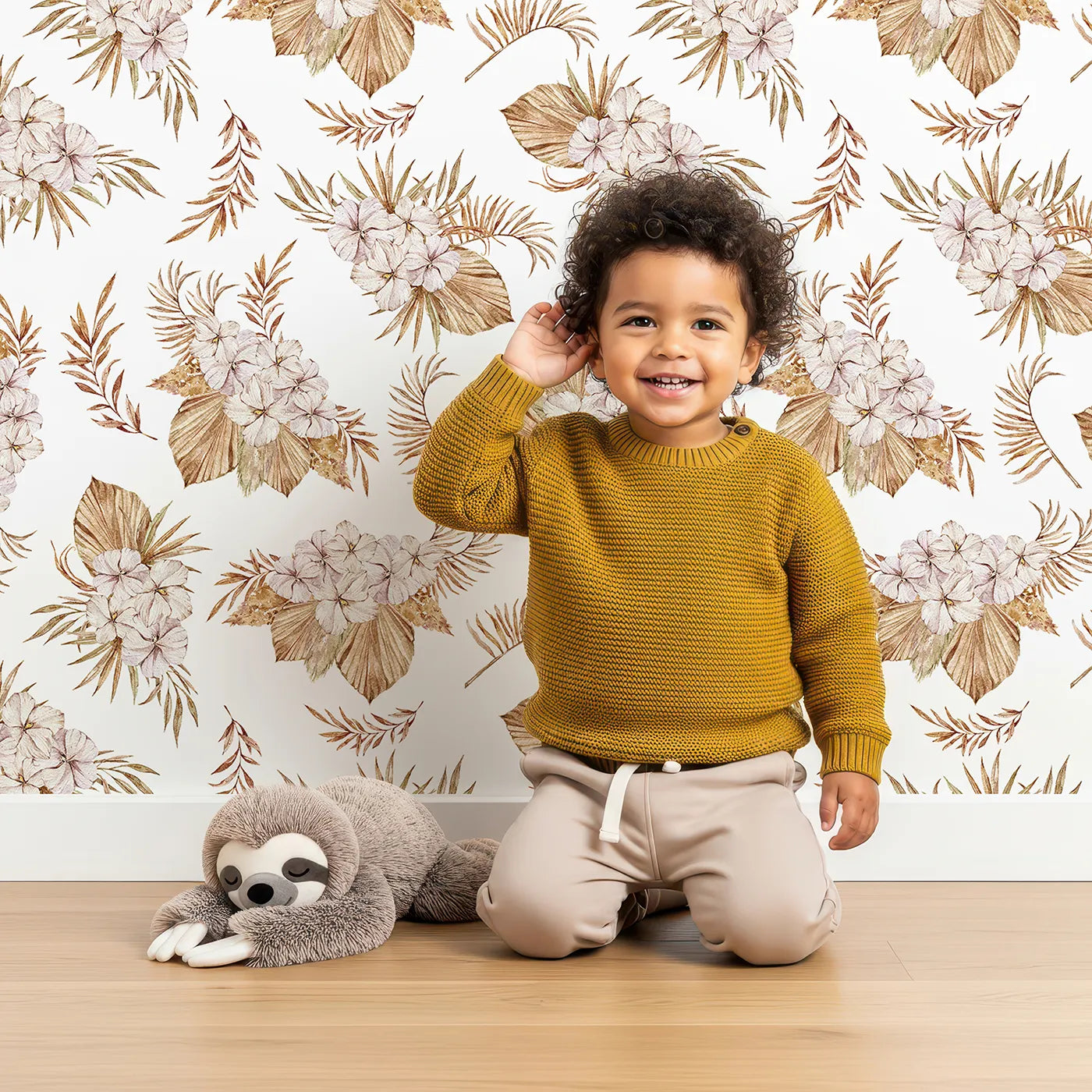 Lovely child standing in front of Whimsy Tots Dried Bloom Cascade Wallpaper in White with flower, palm, leaf in design.