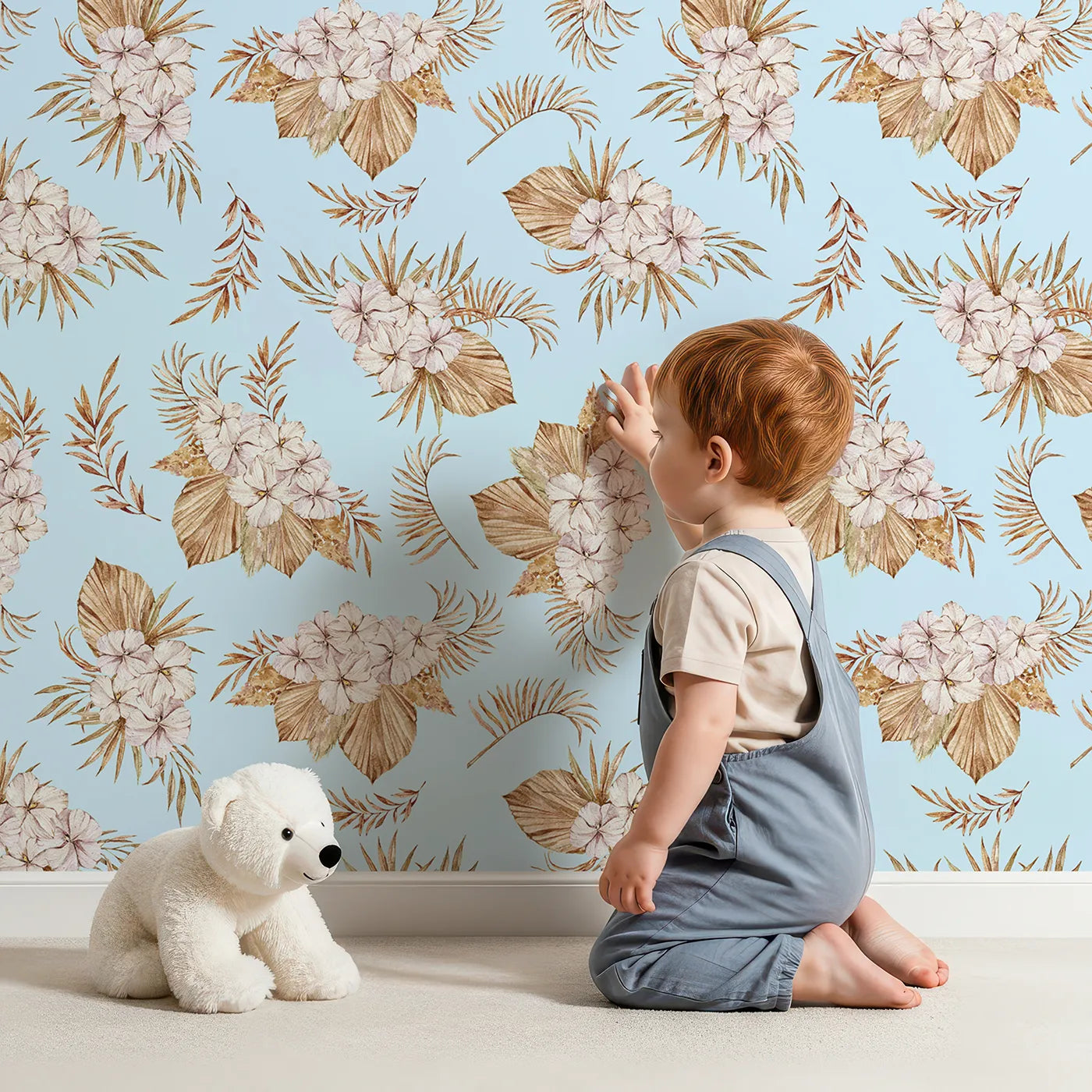 Lovely child standing in front of Whimsy Tots Dried Bloom Cascade Wallpaper in Blue with flower, palm, leaf in design.