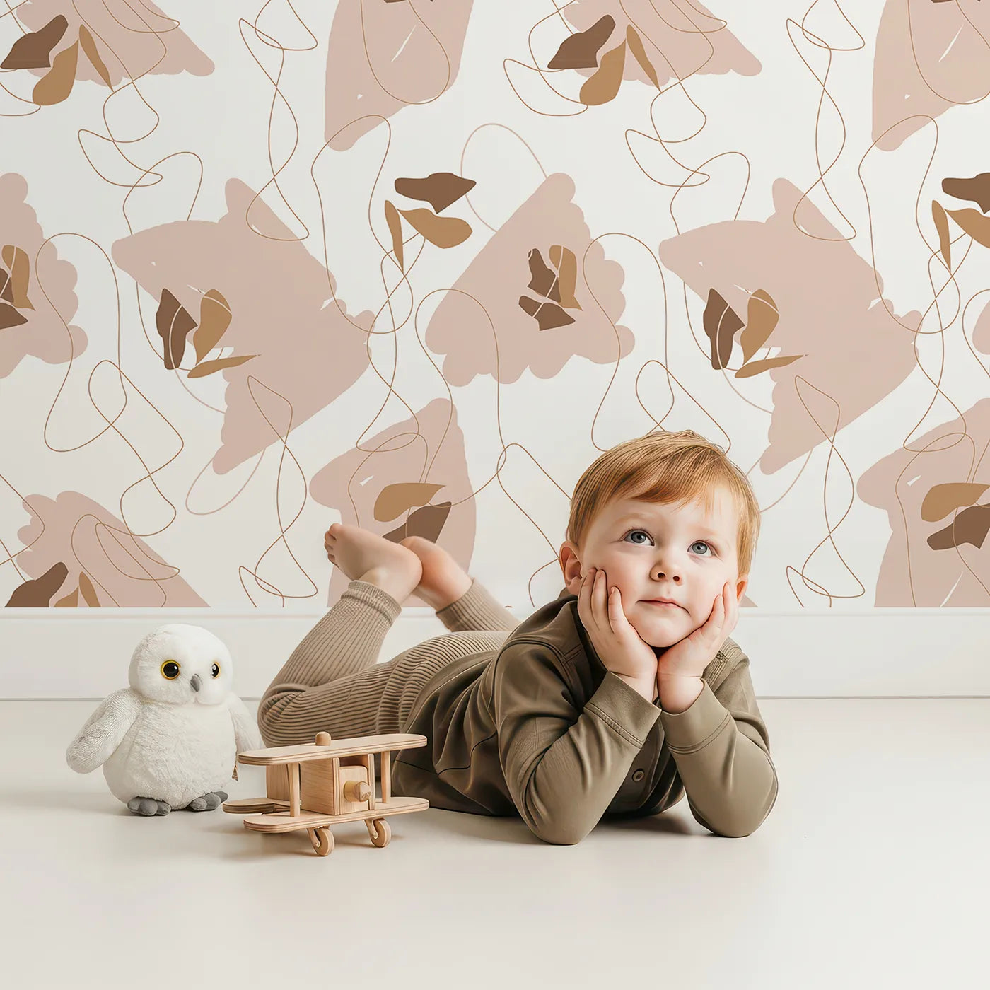 Lovely child standing in front of Whimsy Tots Desert Whimsy Scribbles Wallpaper with shape, line, blob, scribble in design.