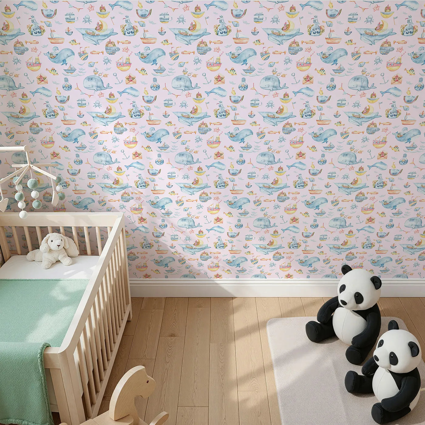 Top-Down view of Whimsy Tots' Whale Mail Wallpaper in Pink (W3313B).Whimsical whales swim through pink skies with tiny ocean treasures in tow.