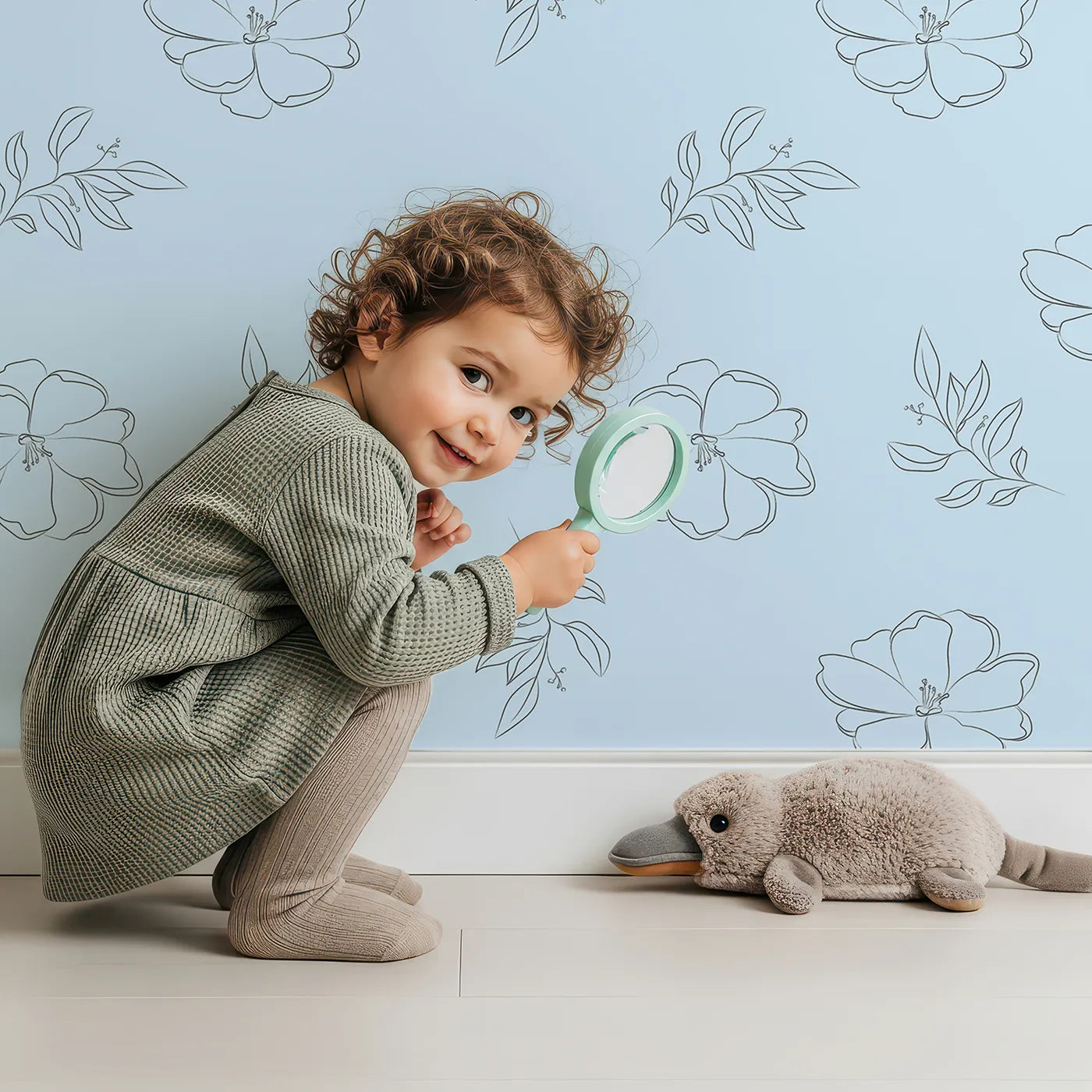 Lovely child standing in front of Whimsy Tots Line Art Camellia Wallpaper in Sky with flower, camellia, lineart, leaf in design.