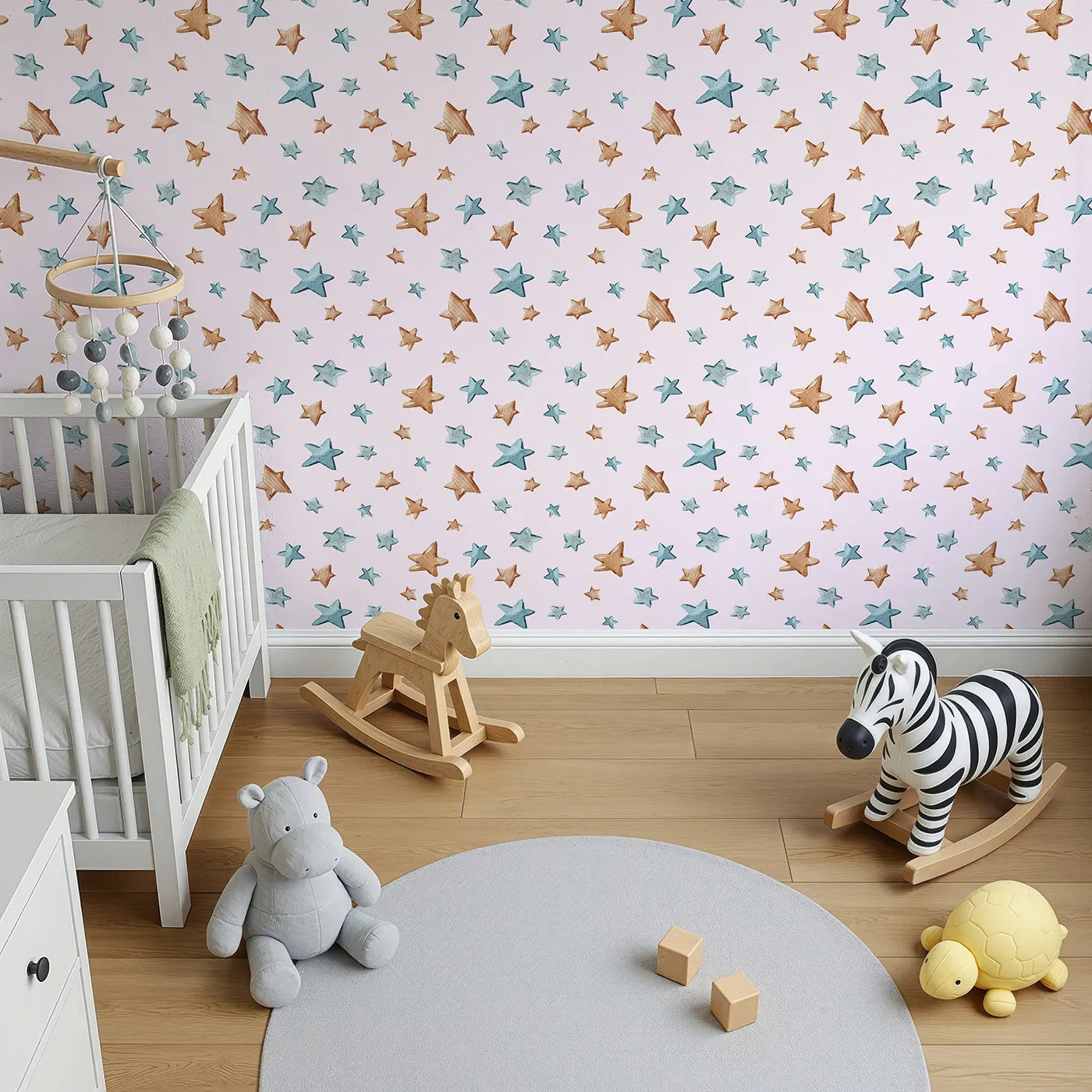 Top-Down view of Whimsy Tots' Starry Drift Wallpaper in Pink (W3341B).Blue and brown watercolor stars twinkle gently over soft pink skies.