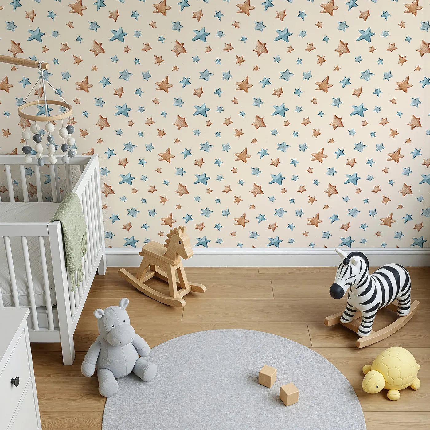 Top-Down view of Whimsy Tots' Starry Drift Wallpaper in Cream (W3341C).Blue and brown watercolor stars float across a soft cream backdrop.