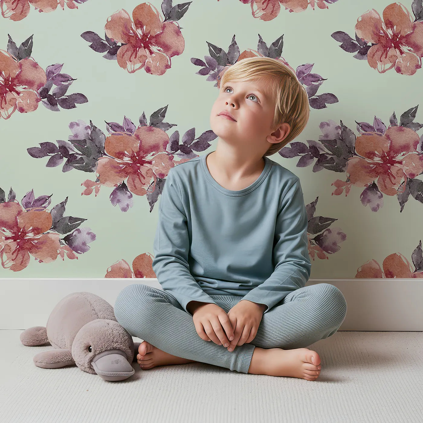 Lovely child standing in front of Whimsy Tots Berry Blush Blooms in Mint Green with flower, petal, leaf, sprig in design.