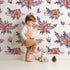 Lovely child standing in front of Whimsy Tots Berry Meadow Whispers in White with flower, leaf, petal, sprig in design.