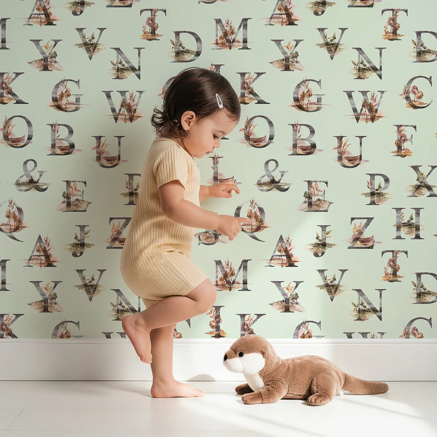 Lovely child standing in front of Whimsy Tots Rustic Alphabet Adventure in Mint Green with letter, alphabet, tree, boat, plant in design.
