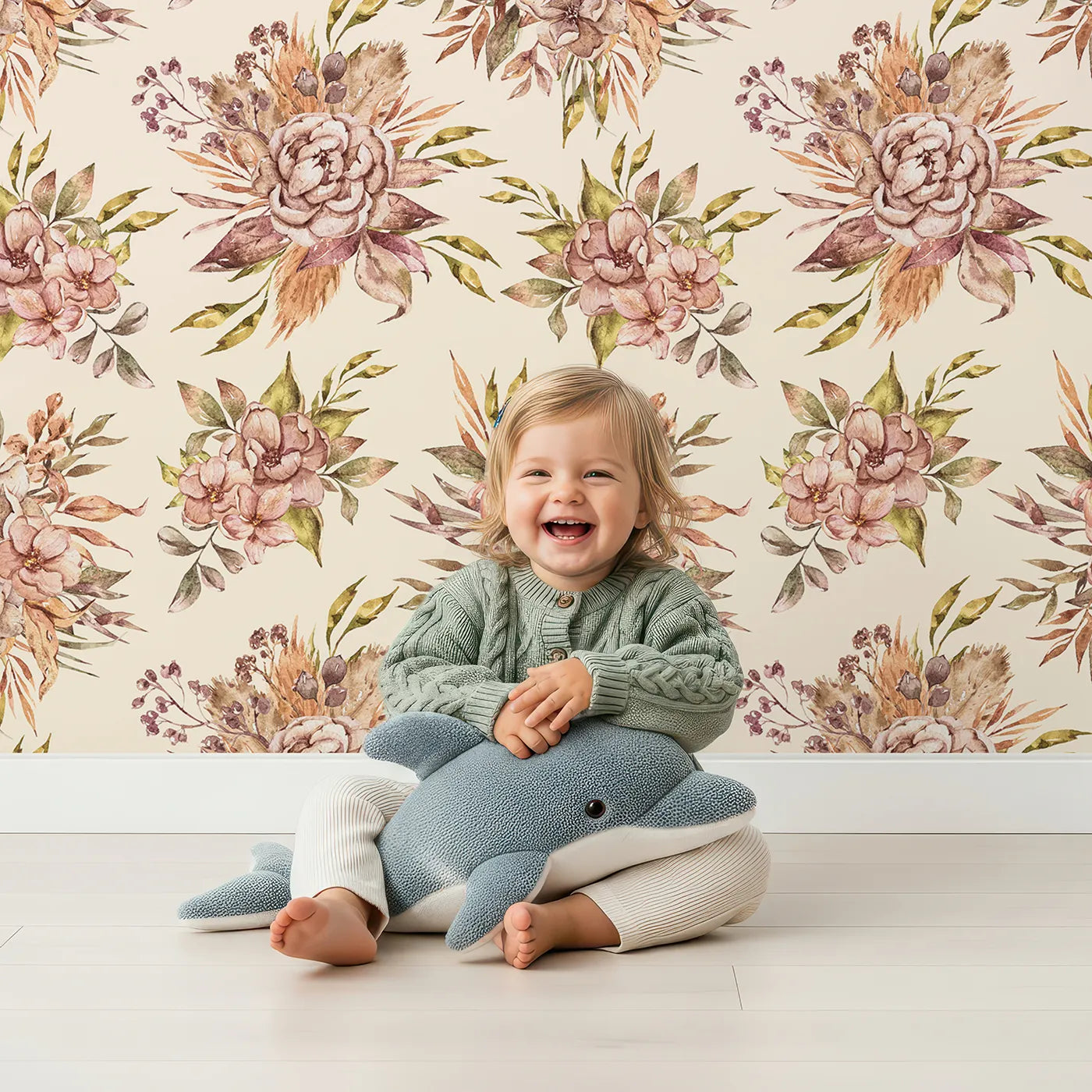 Lovely child standing in front of Whimsy Tots Autumn Bloom Harmony Wallpaper in Cream with flower, leaf, peony, bouquet in design.