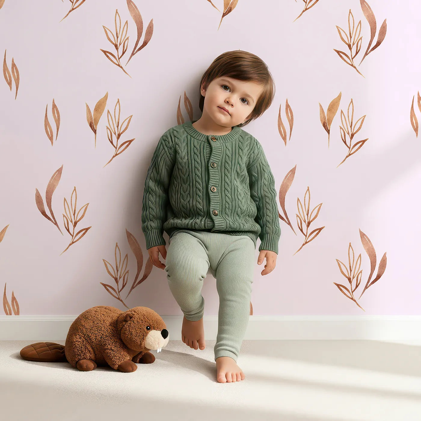 Lovely child standing in front of Whimsy Tots Rustling Meadow Sprigs Wallpaper in Blush Pink with leaf, sprig, botanical, plant in design.