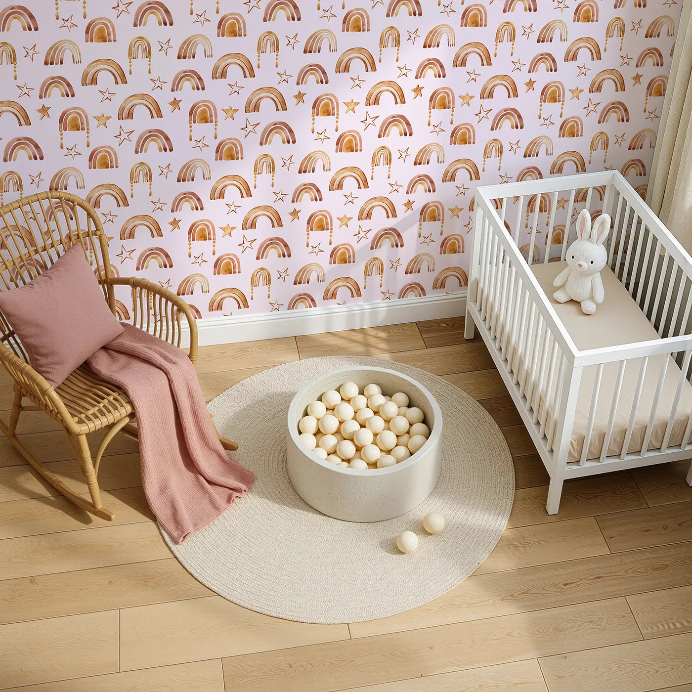 Top-Down view of Whimsy Tots' Golden Boho Rainbows Wallpaper in Blush (W3387B).Warm-toned arches and golden stars shimmer on a gentle blush sky.
