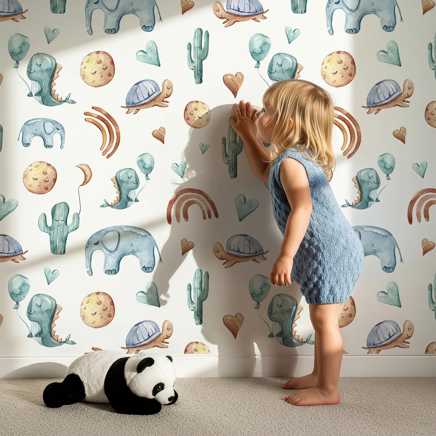 Lovely child standing in front of Whimsy Tots Balloon Friends Parade Wallpaper in White with dinosaur, elephant, turtle, cactus, moon, heart, rainbow in design.