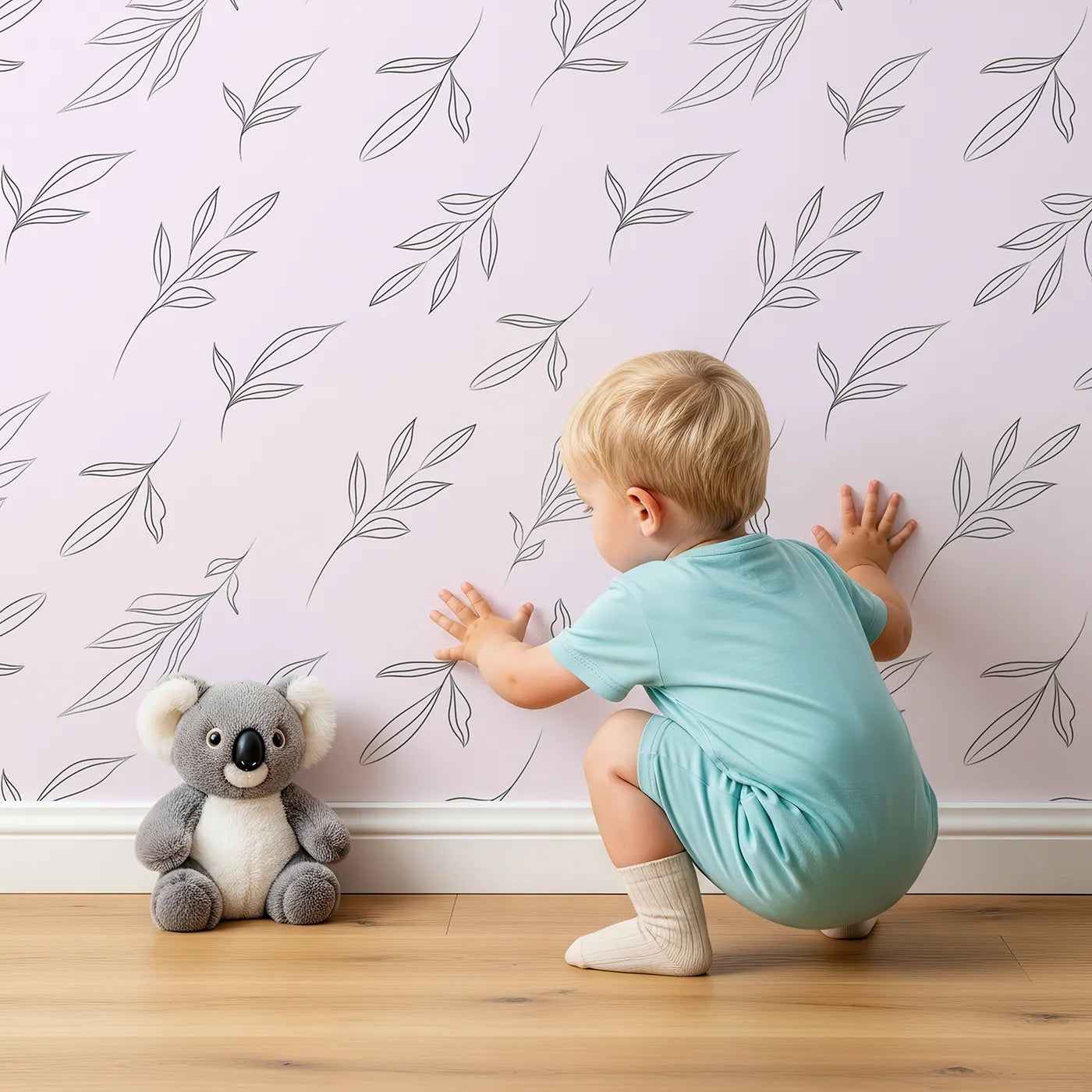 Lovely child standing in front of Whimsy Tots Leaf Outline Symphony Wallpaper in Blush Pink with leaf, branch, botanical, outline in design.