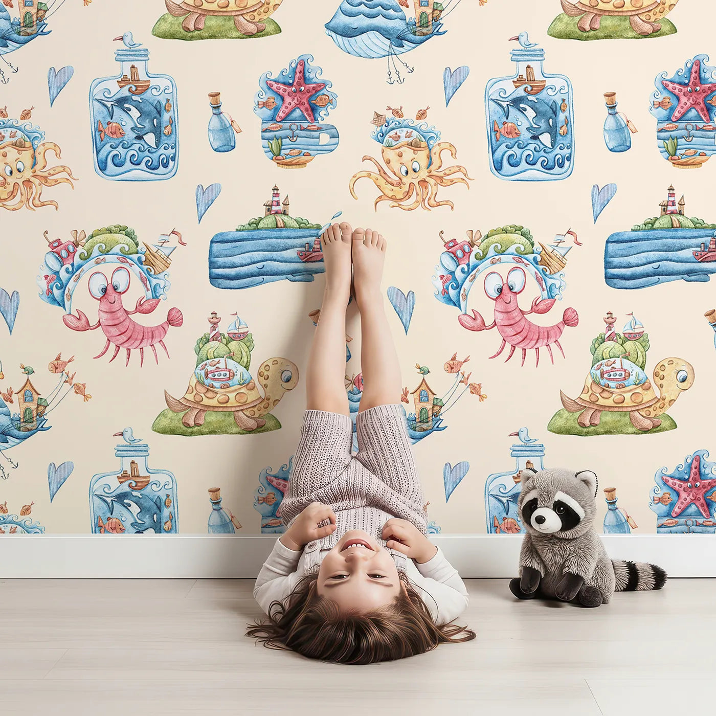 Lovely child standing in front of Whimsy Tots Undersea Island Adventure Wallpaper in Sand with whale, turtle, submarine, starfish, bottle, island, sea creature in design.