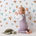 Lovely child standing in front of Whimsy Tots Heartful Whimsy Wallpaper in White with heart in design.