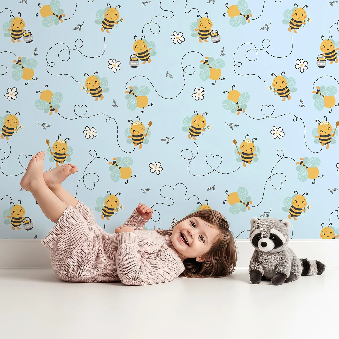 Lovely child standing in front of Whimsy Tots Busy Bees at Play Wallpaper in Sky with bee, flower, heart, honey in design.