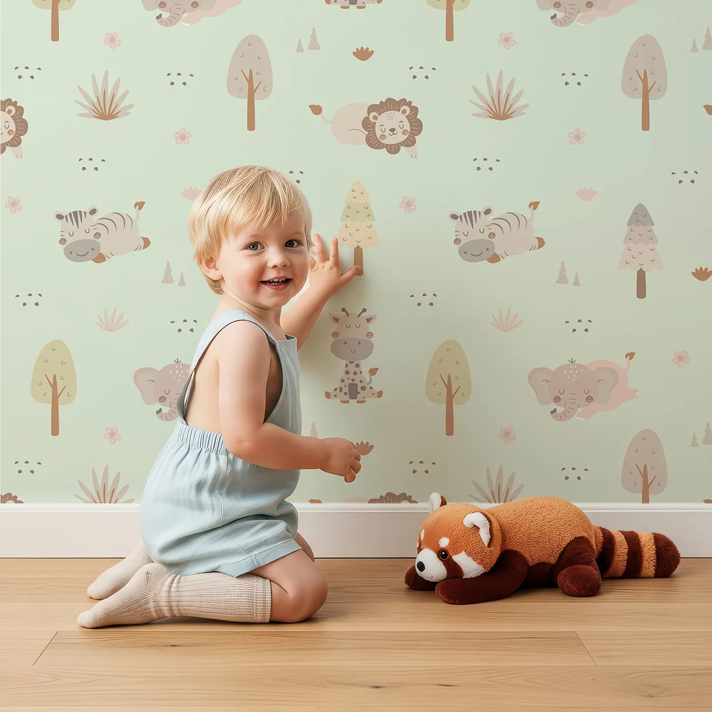 Lovely child standing in front of Whimsy Tots Sleepy Safari Snuggles Wallpaper in Mint Green with elephant, zebra, lion, giraffe, hippo, tree, flower in design.