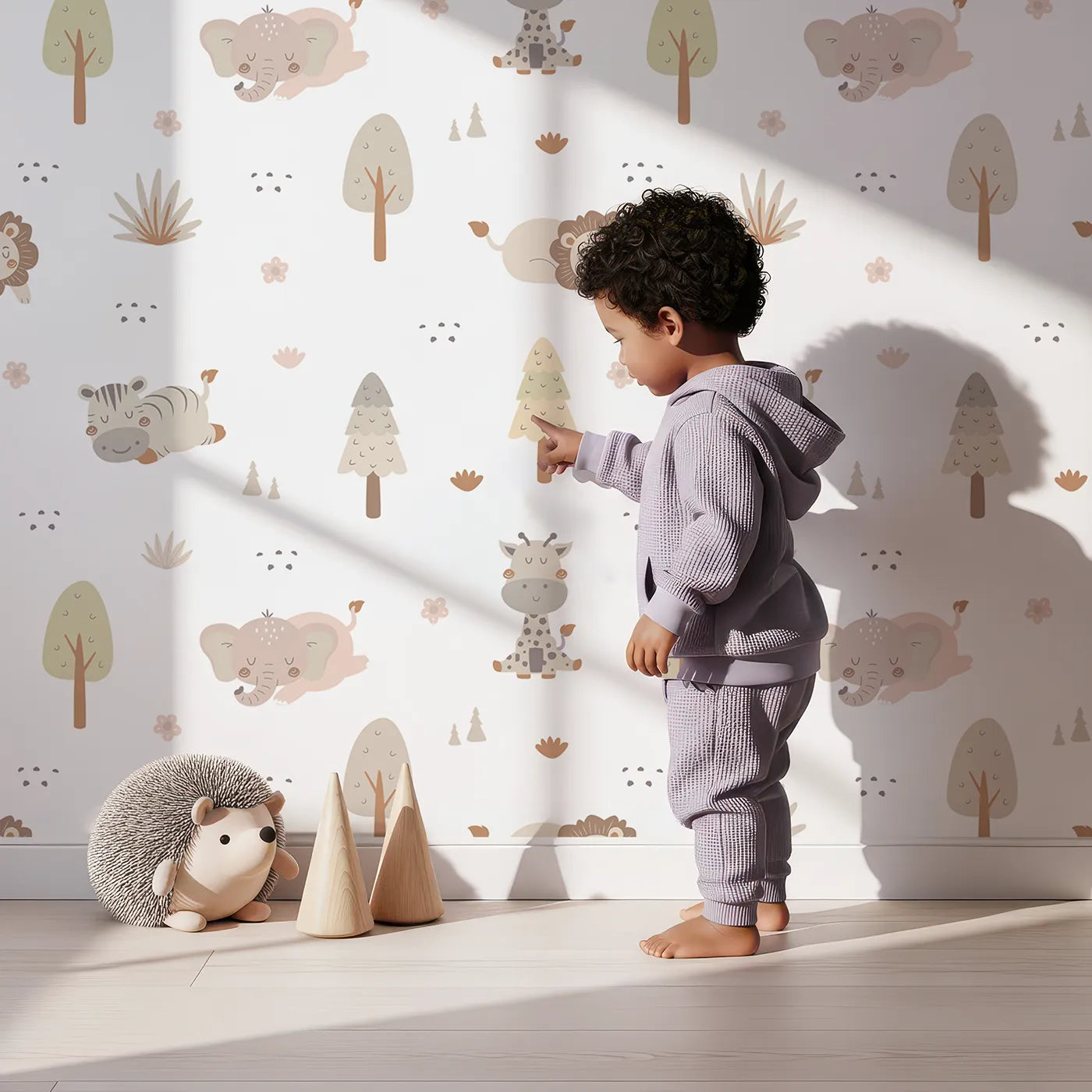 Lovely child standing in front of Whimsy Tots Sleepy Safari Snuggles Wallpaper in Soft White with elephant, zebra, lion, giraffe, hippo, tree, flower in design.
