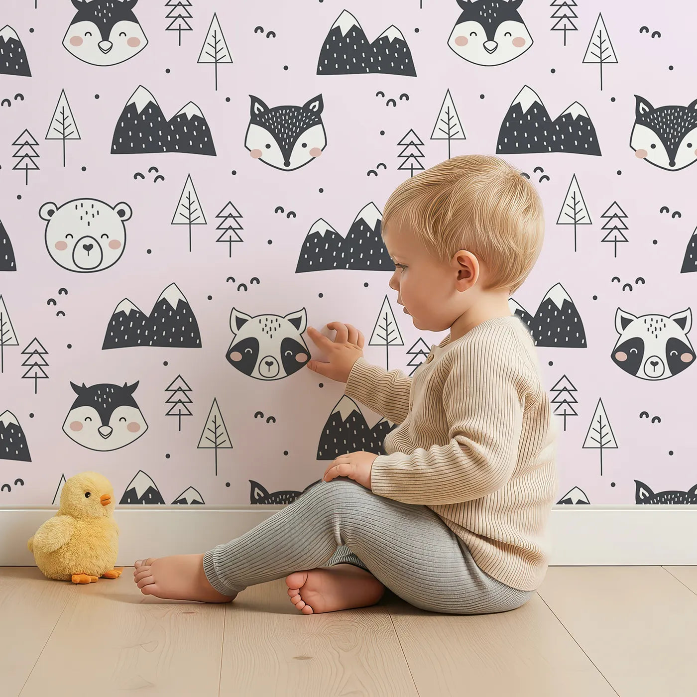 Lovely child standing in front of Whimsy Tots Woodland Peekaboo Friends Wallpaper in Pink with bear, owl, fox, raccoon, mountain, tree in design.