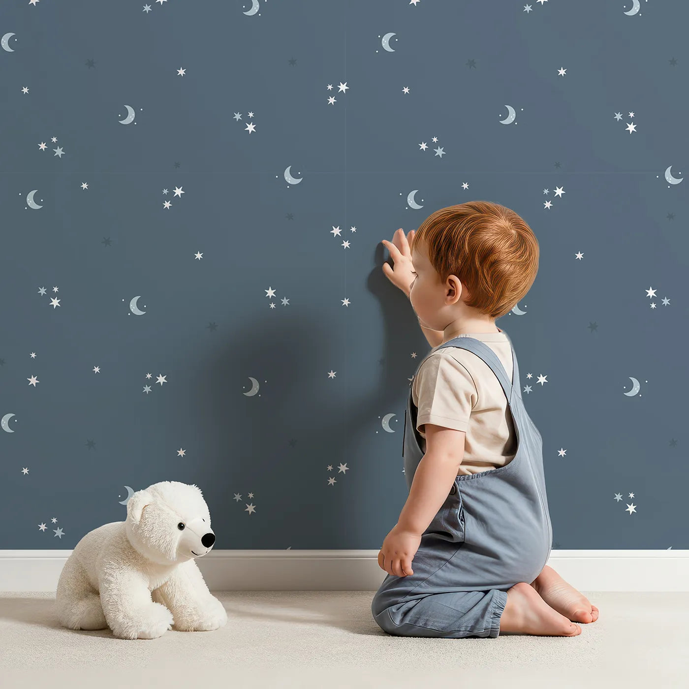 Lovely child standing in front of Whimsy Tots Starry Night Whispers Wallpaper in Navy with moon, star in design.