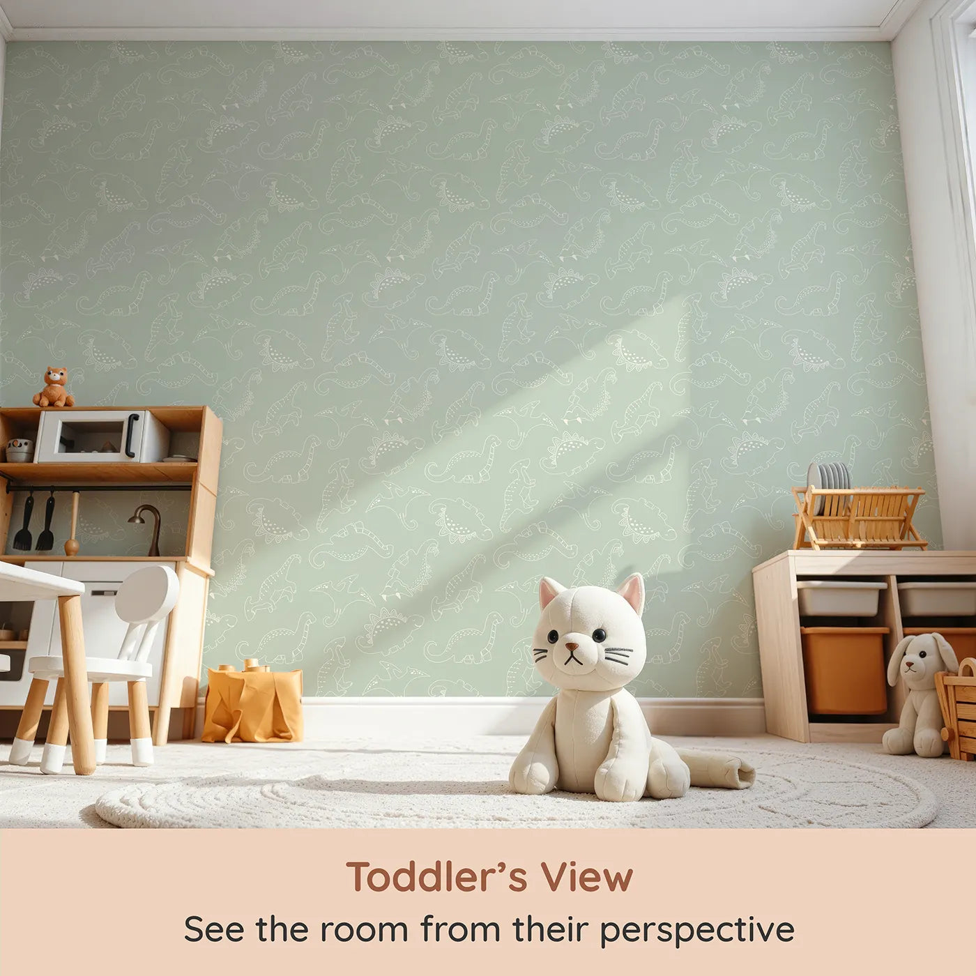Whimsy Tots Dino Scribble Parade Wallpaper in Sage Green (W3466D) from your child's view.Creamy dinos stroll calmly across a pale sage green sky.