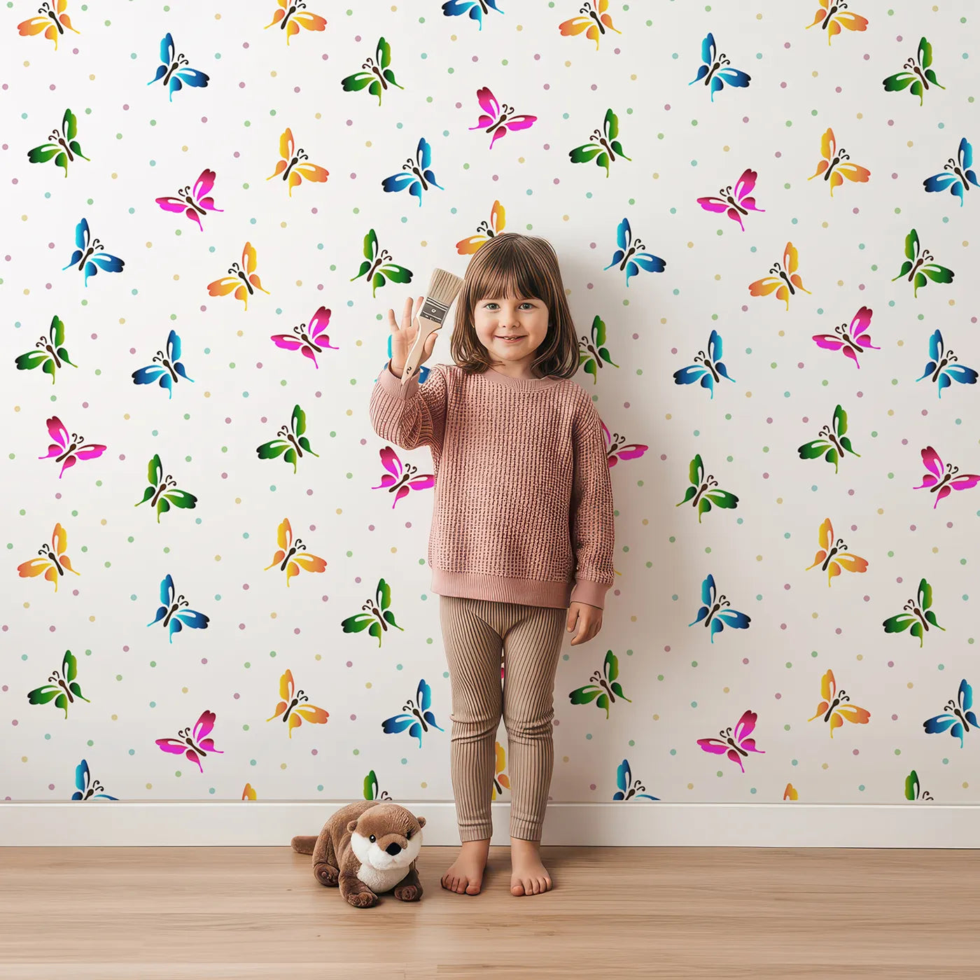 Lovely child standing in front of Whimsy Tots Rainbow Flutter Parade Wallpaper in White with butterfly, dot, wing, rainbow in design.