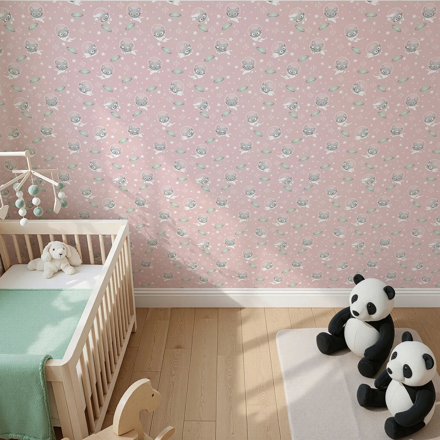 Top-Down view of Whimsy Tots' Space Kitty Drift Wallpaper in Blush Pink (W3480B).Astronaut cats drift across a gentle pink sky of stars and planets.