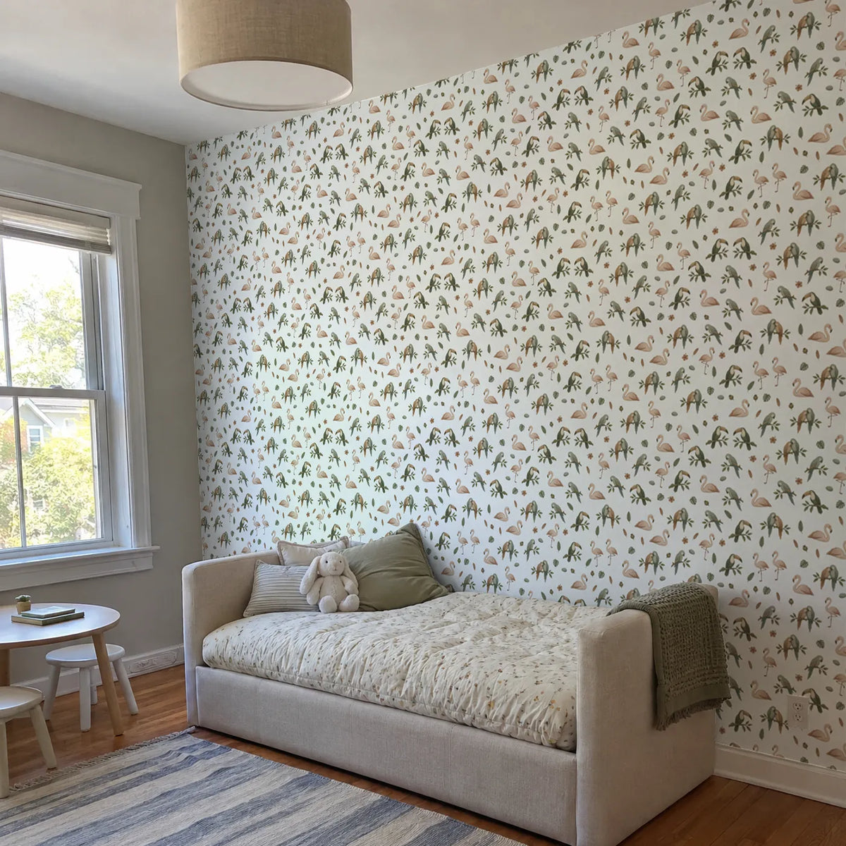 Gouache wallpaper of resting flamingos, parrots and toucans, in a room photo, by Whimsy Tots