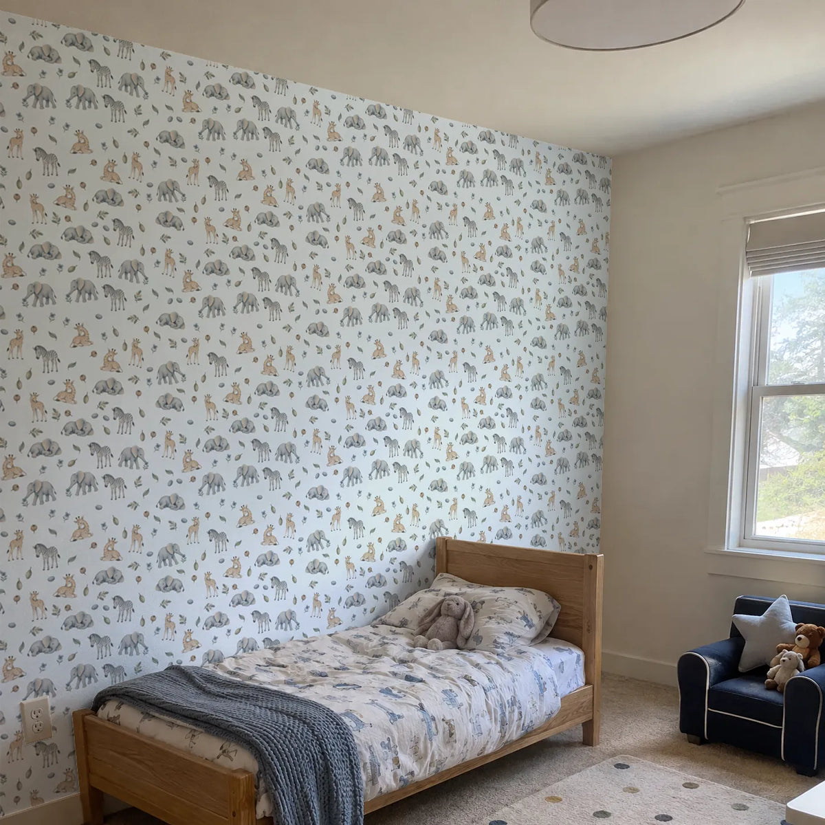Watercolor wallpaper of sleepy elephant and giraffe calves, in a room photo, by Whimsy Tots