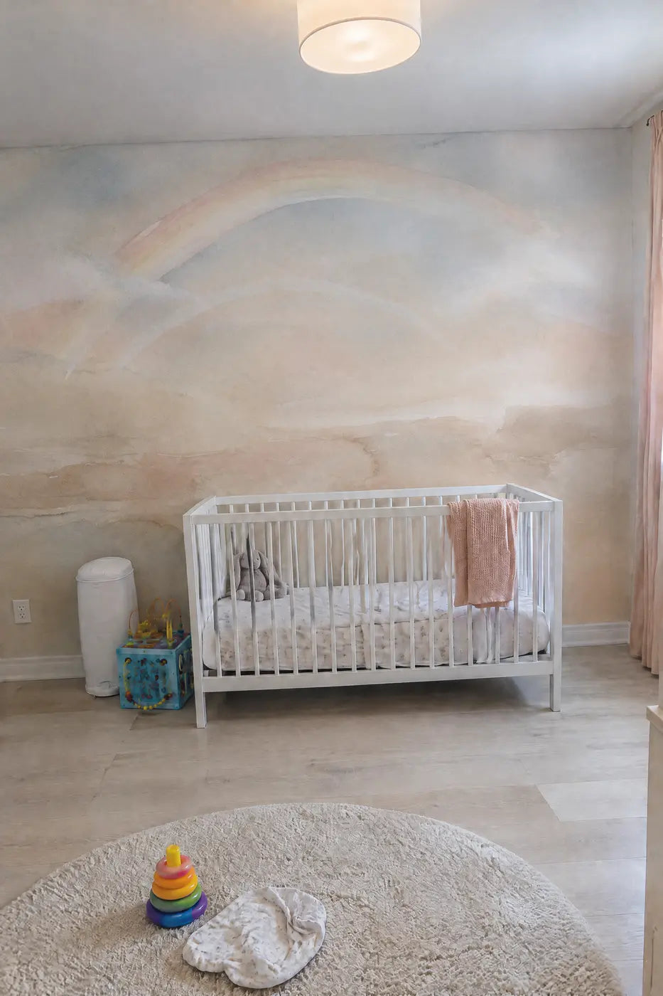 Soft Rainbow Arc Wallpaper Mural in a nursery by Whimsy Tots